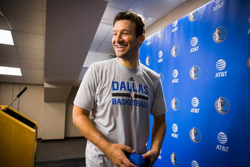 Tony Romo smiles as he leaves a press confernce following the Dallas Mavericks morning...