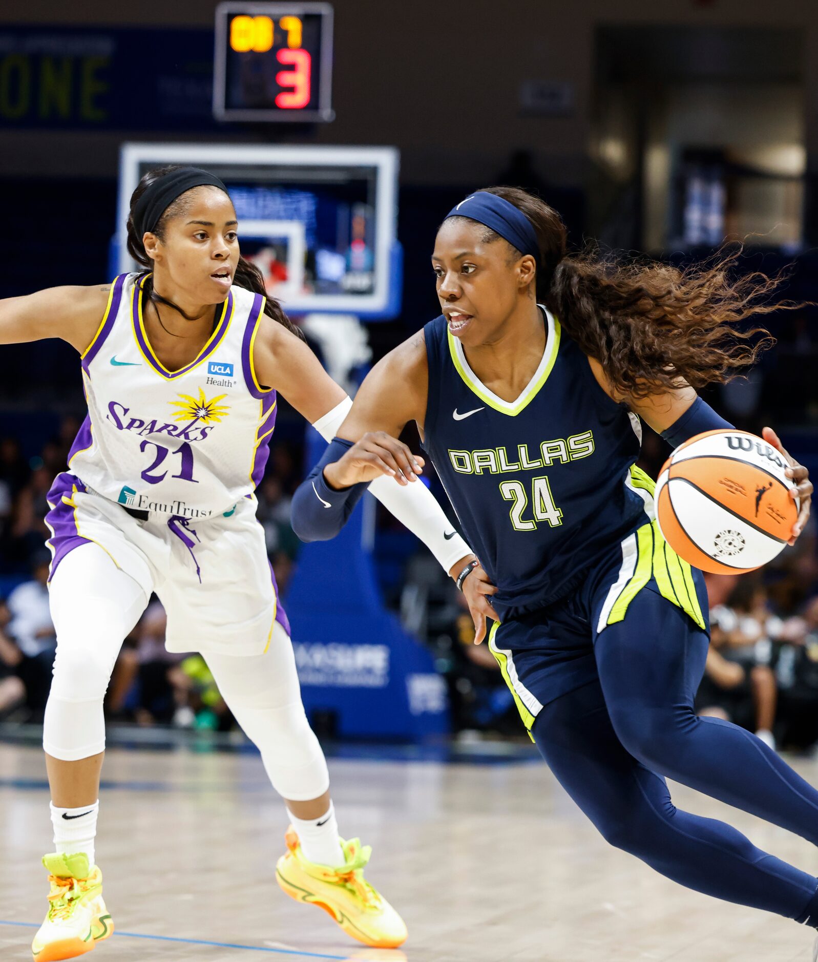 Dallas Wings guard Arike Ogunbowale (24) dribbles past Los Angeles Sparks guard Jordin...