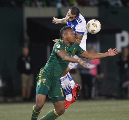 Portland Timbers' Jeremy Ebobisse (17) collides with FC Dallas' Marquinhos Pedroso (6) while...
