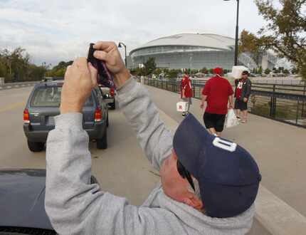 Stan Shults put his Dallas Cowboys flag on his antenna as he waited in line to tailgate...