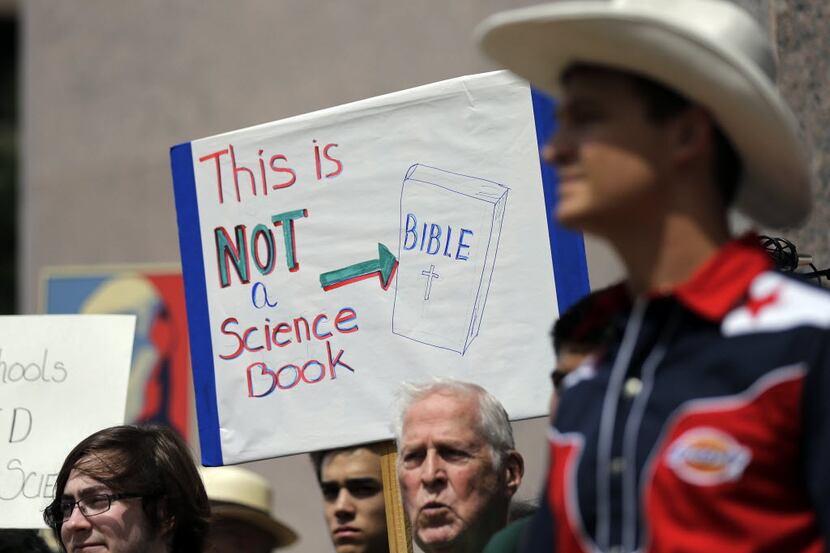  Pro-science supporters rally prior to a State Board of Education public hearing on proposed...