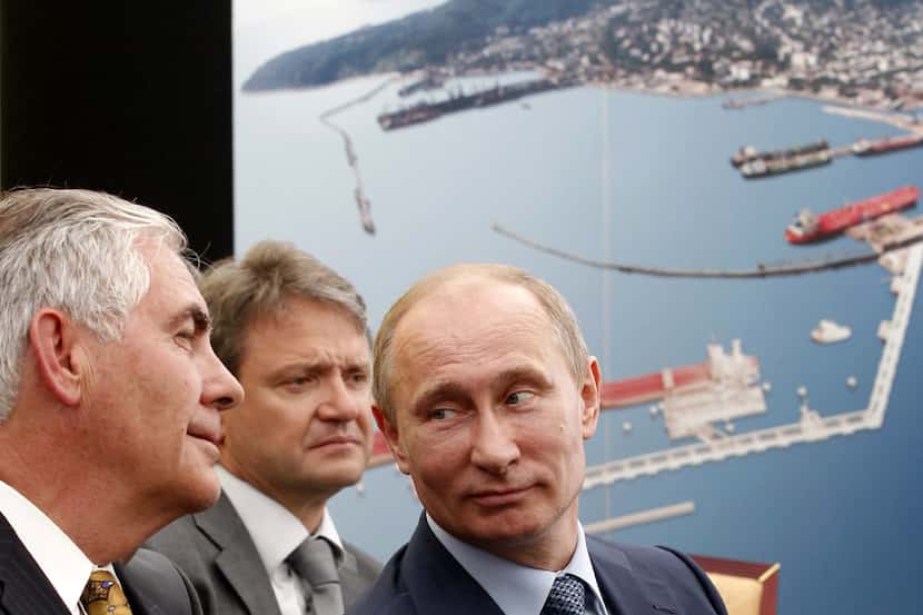 Former Exxon CEO Rex Tillerson (left) talks with Russia's President Vladimir Putin at a 2012...