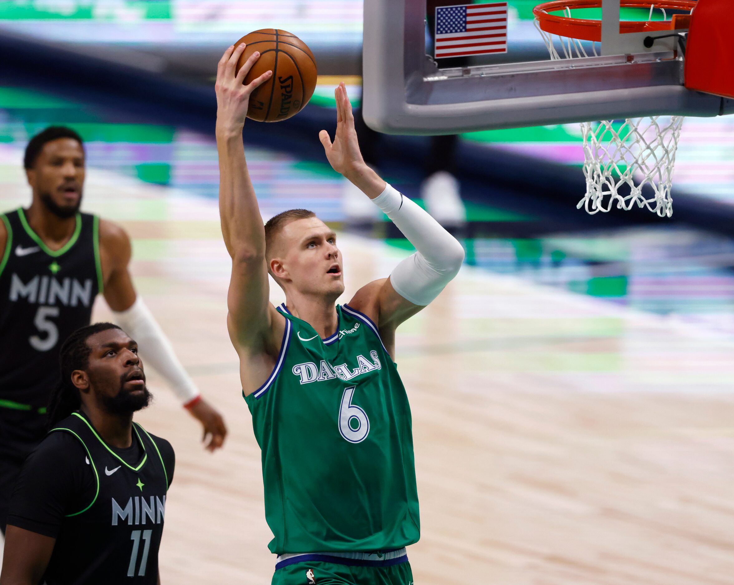 Dallas Mavericks forward Kristaps Porzingis (6) goes up for a dunk as Minnesota Timberwolves...