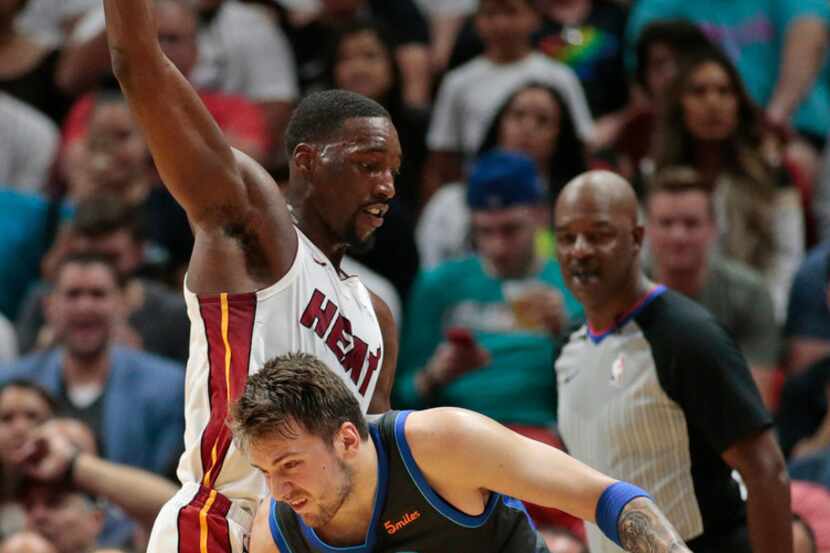Dallas Mavericks forward Luka Doncic (77) drives against Miami Heat center Bam Adebayo (13)...