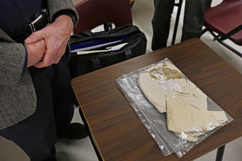 Dr. Robert McClelland shows the blood-stained shirt he wore while tending to President John...