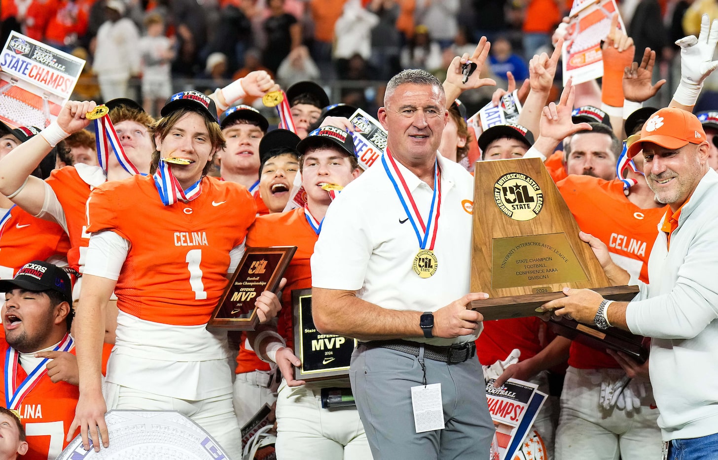 Celina head coach Bill Elliott is presented with the trophy alongside offensive MVP Bowe...