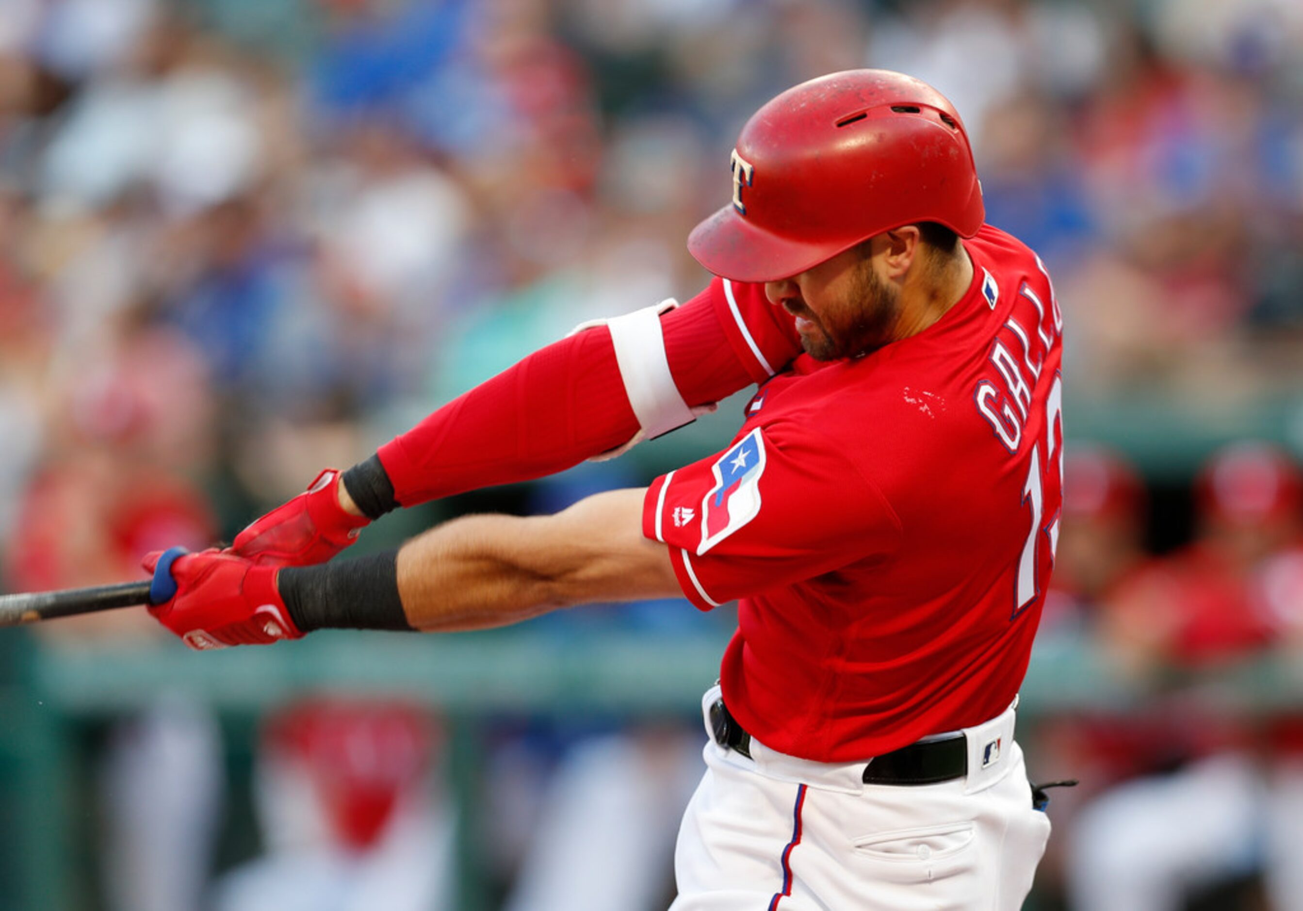 Texas Rangers' Joey Gallo follows through on his two-run home against the Colorado Rockies...