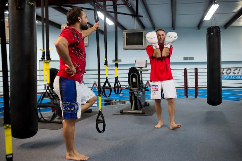 NASCAR driver Kevin Harvick goofs around during his training session with MMA fighter Johny...