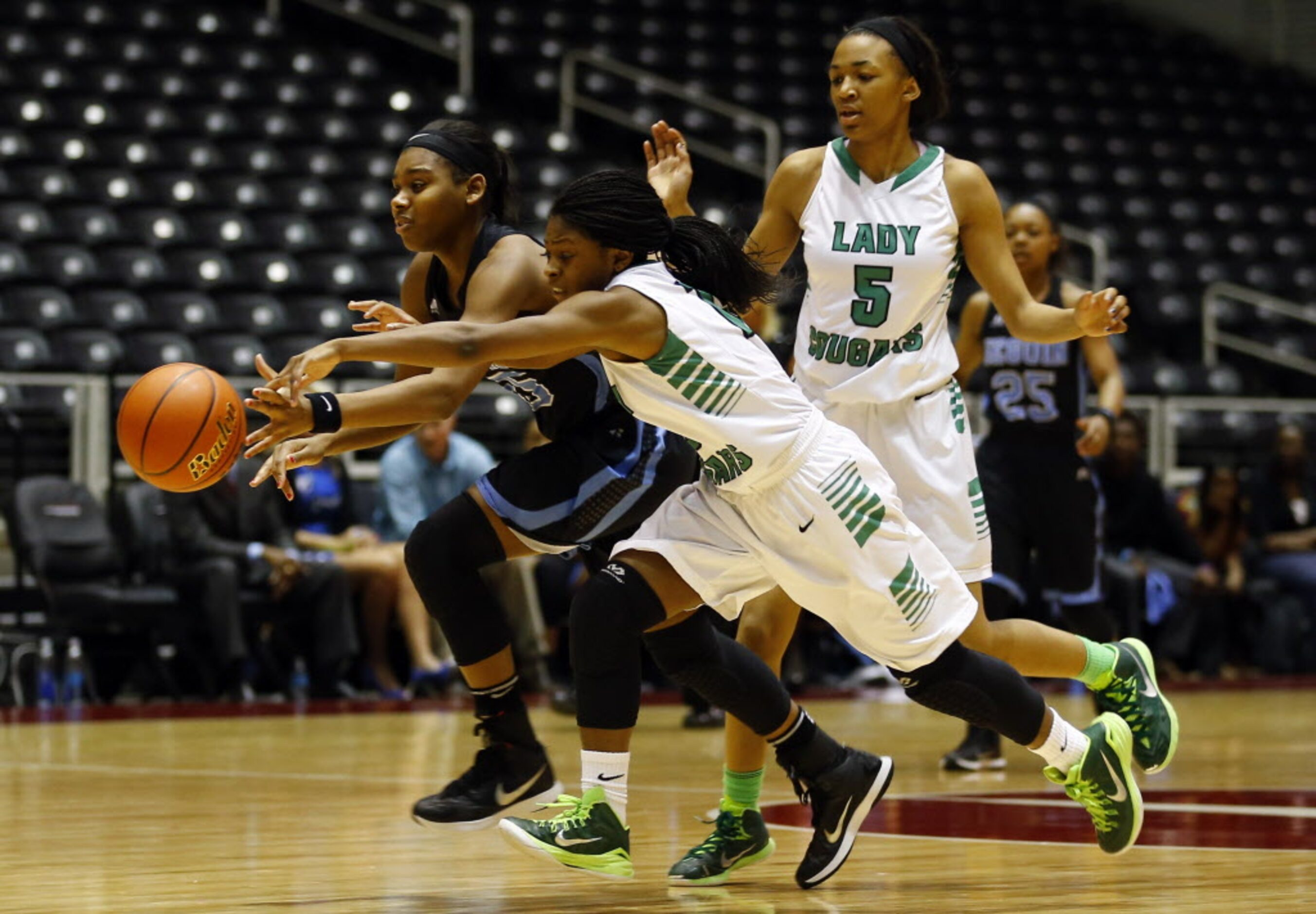 Arlington Seguin's Alarie Mayze (45) tries to beat Bryan Adams' DeBrashia Baty (15) up the...