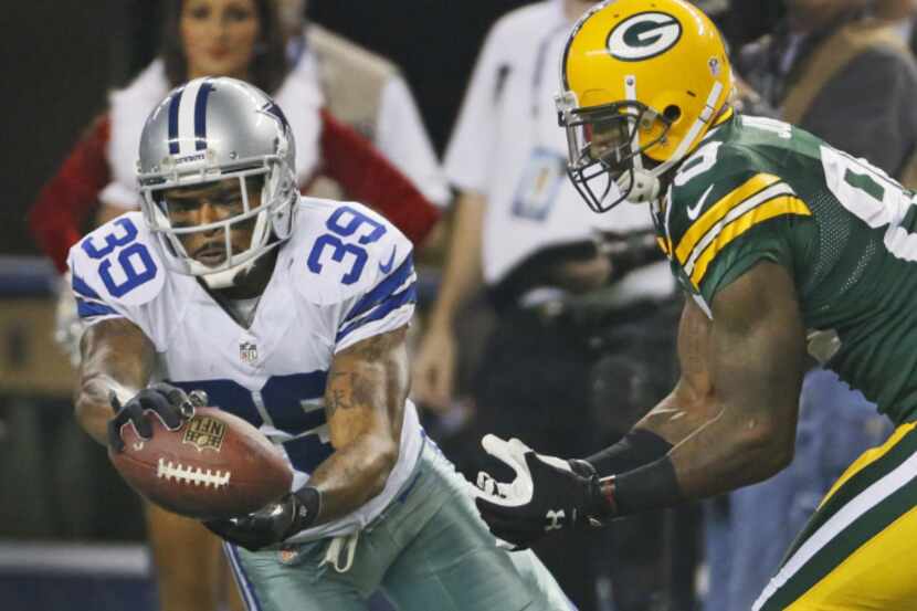 Dallas Cowboys cornerback Brandon Carr (39) breaks up a pass intended for Green Bay Packers...