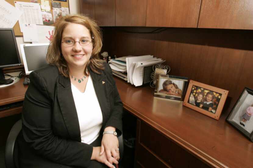 Denise Merkel keeps pictures of her daughters on her desk at PyraMax Bank in Greenfield, Wis.