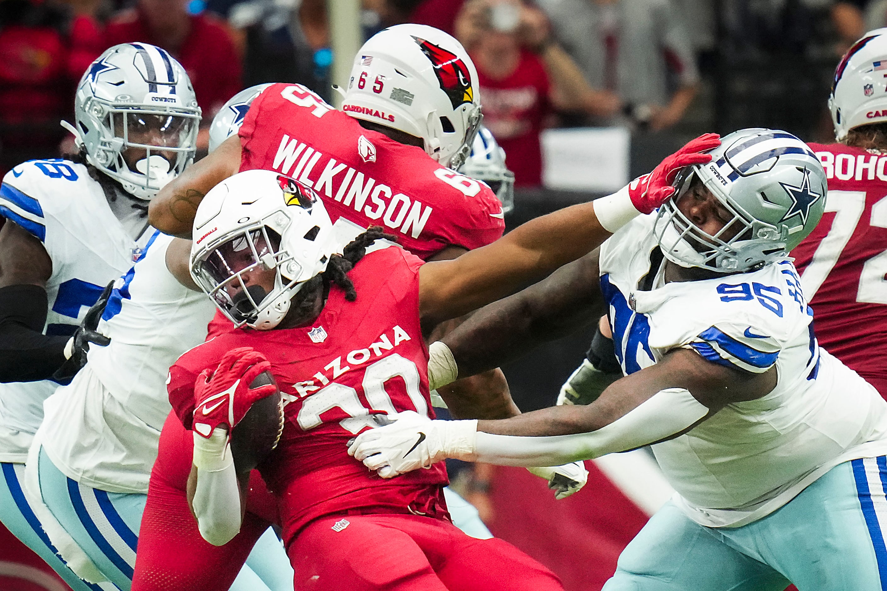 Arizona Cardinals running back Keaontay Ingram (30) pushes away from Dallas Cowboys...