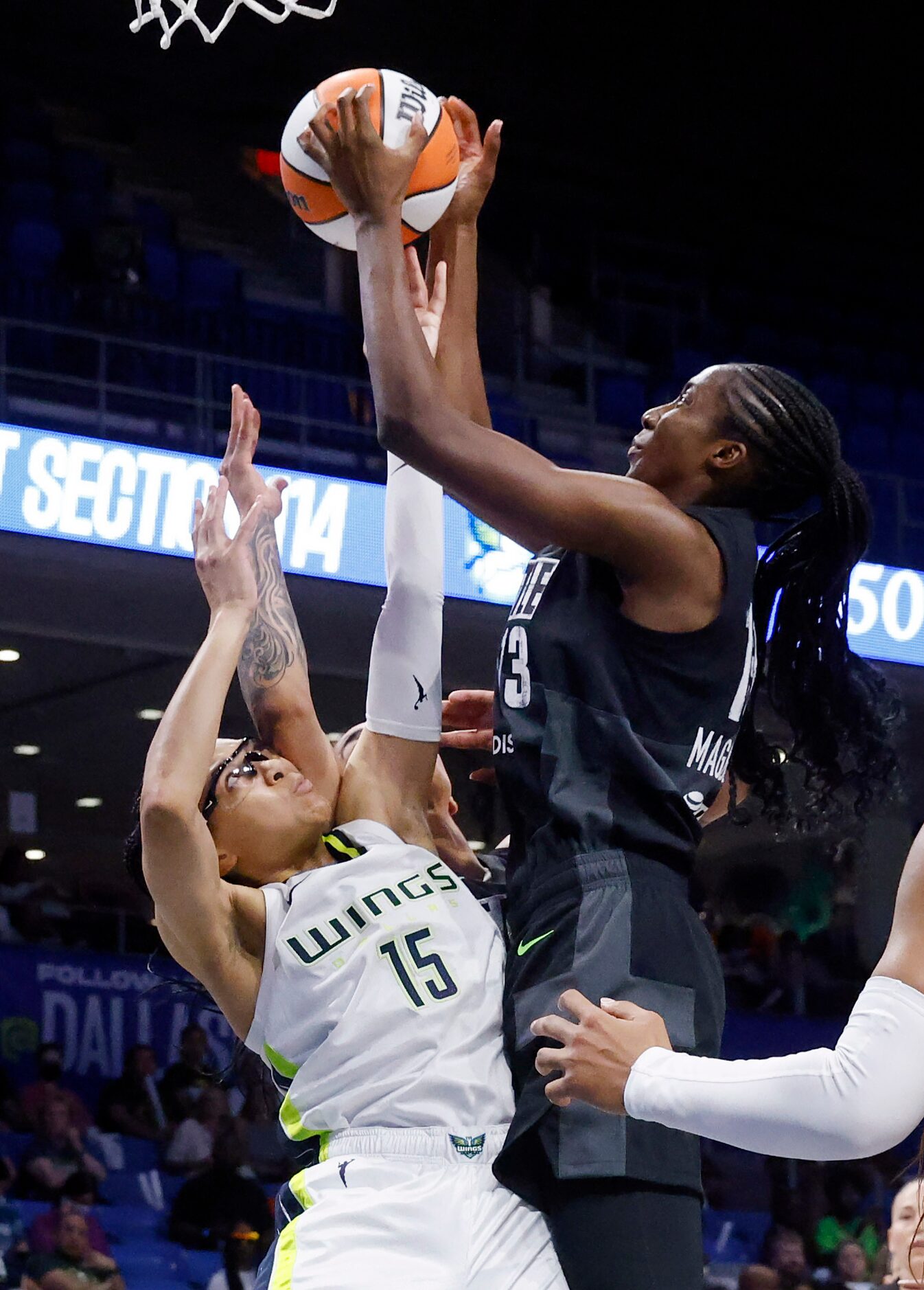 Dallas Wings guard Allisha Gray (15) and Seattle Storm center Ezi Magbegor (13) battle for a...