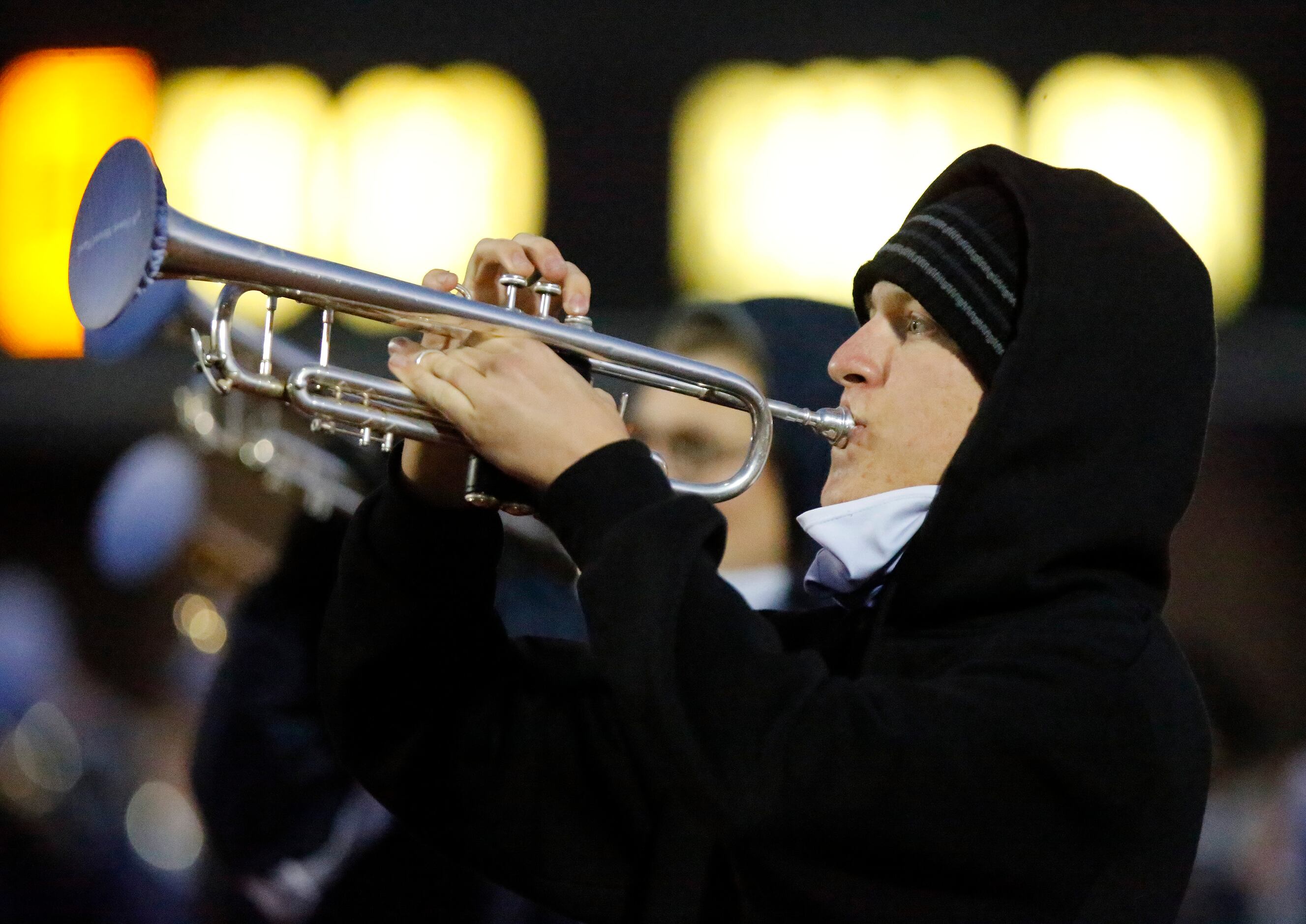17 year-old Randy Lee plays trumpet during the fight song for Flower Mound High School...