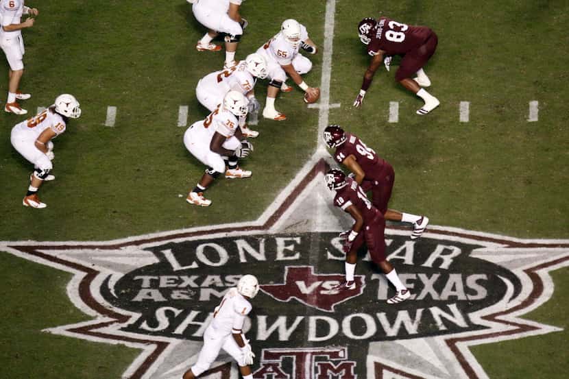 FILE - The Texas Longhorns' offense lines up against the Texas A&M defense during a game at...