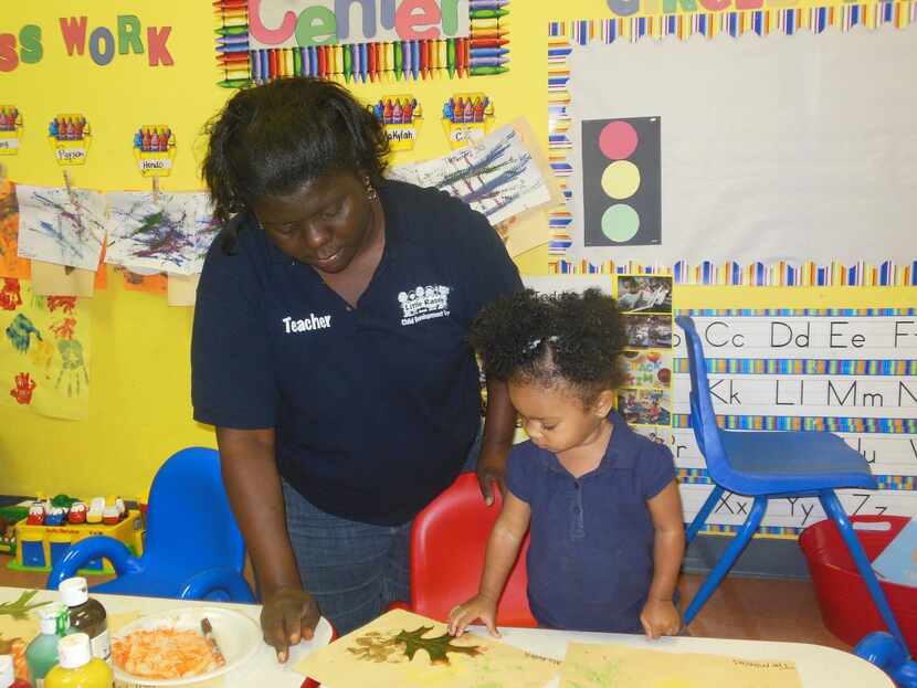 
Tomeco Hudson, teacher for 1-year-olds at Little Rascals, works with student Makylah Gibson.
