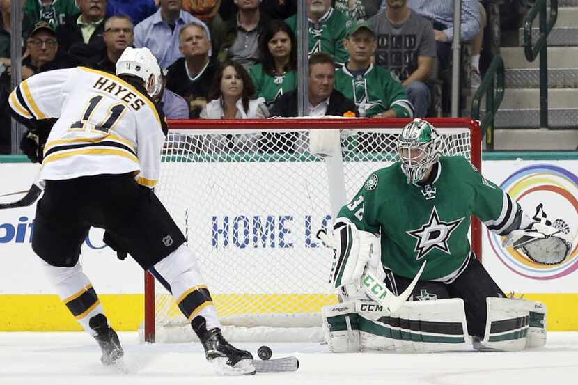 Boston Bruins right wing Jimmy Hayes (11) makes a shot on goal against Dallas Stars goalie...