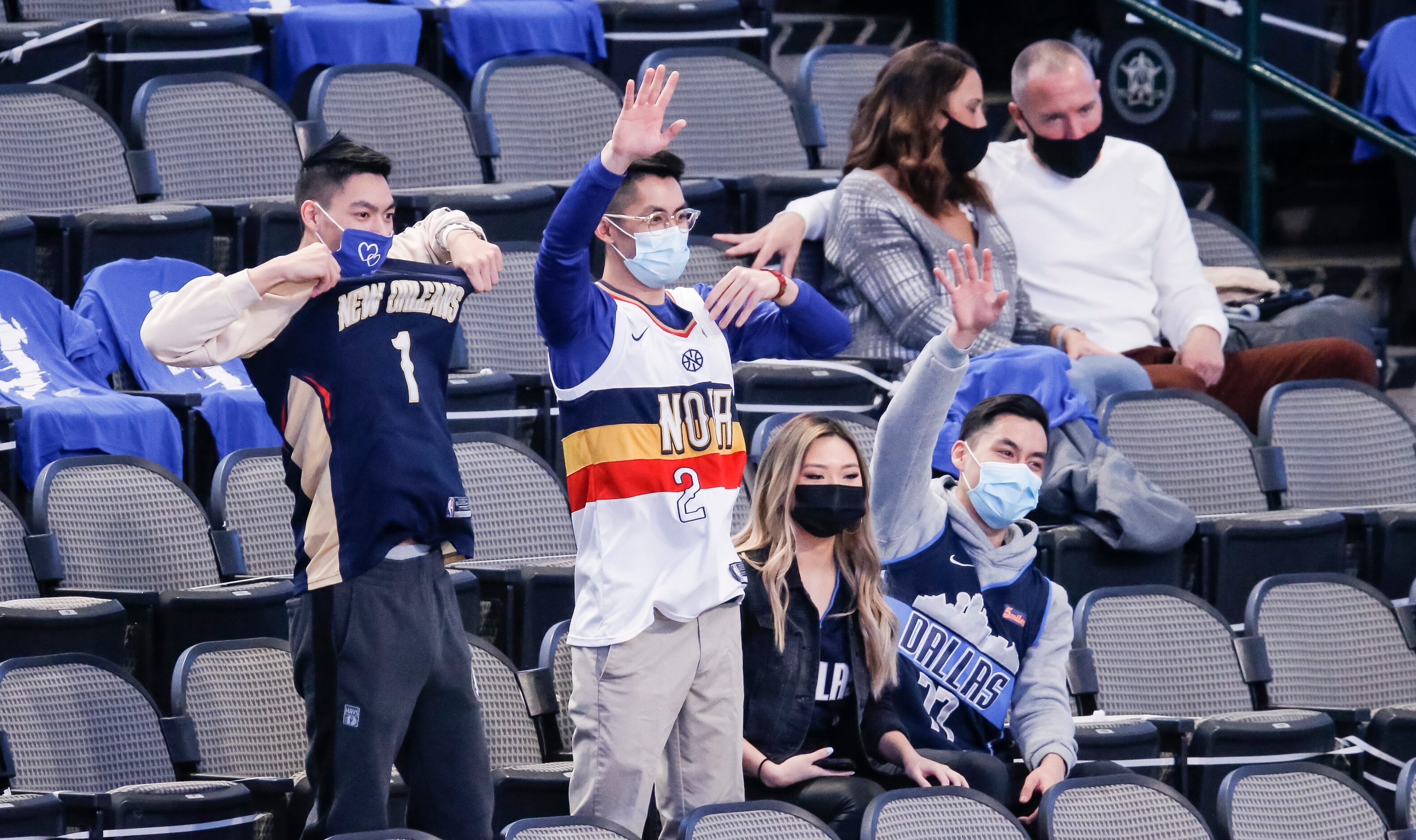 Fans, consisting mostly of healthcare workers, cheer on their respective teams during an NBA...