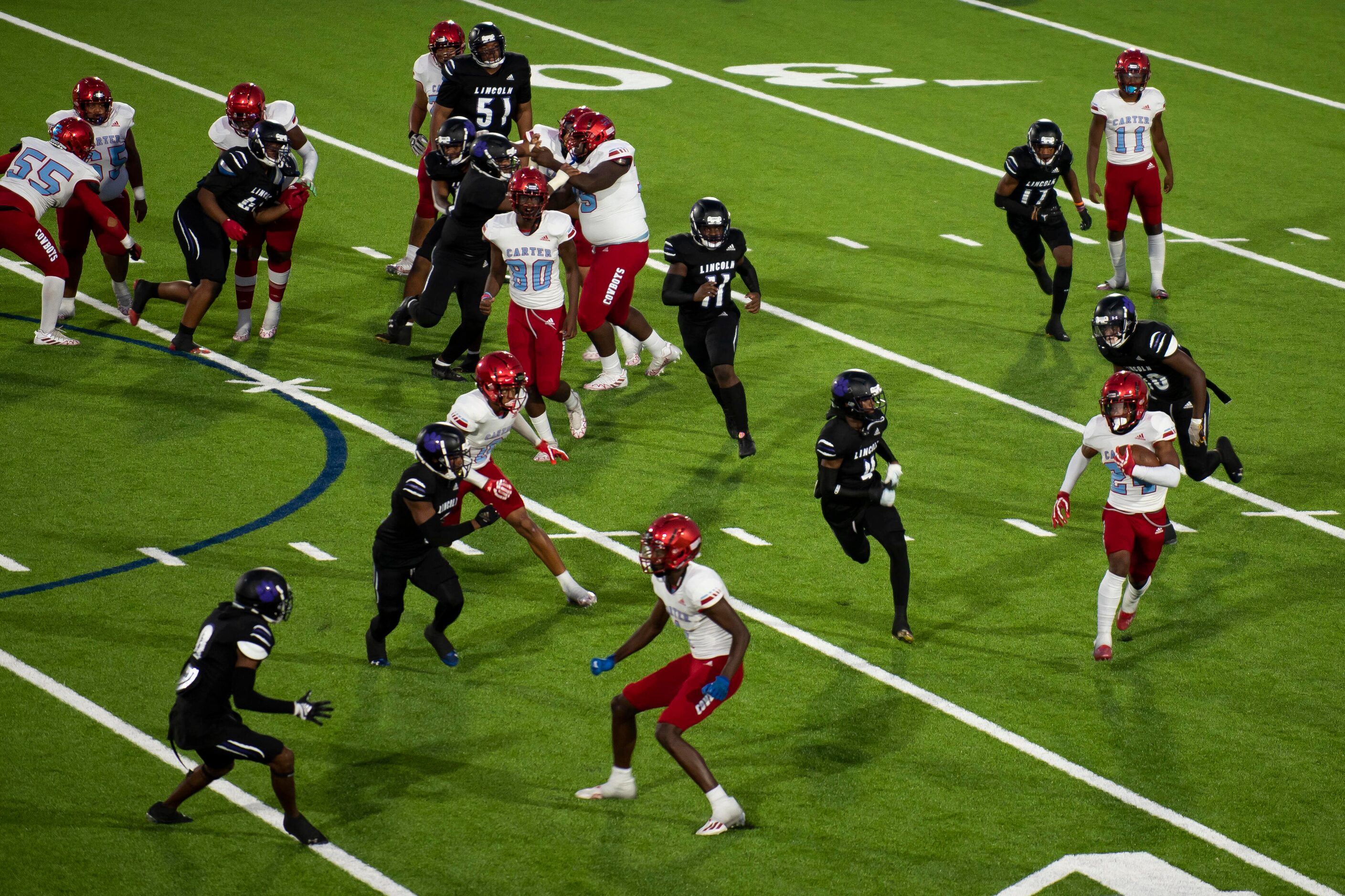 Carter junior Kaeden Landry (24) runs across the field to gain yardage during a high school...