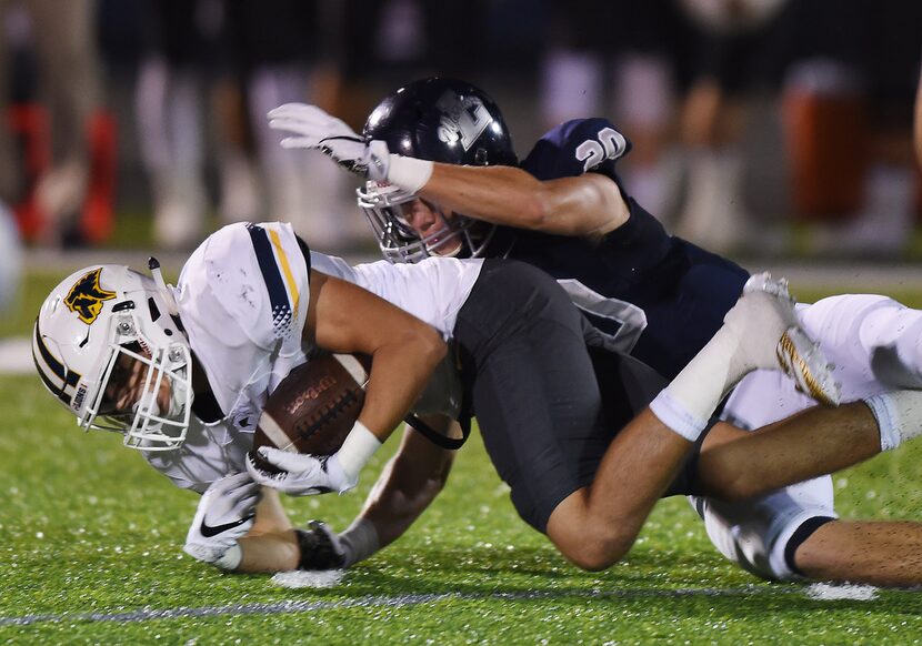 Liberty Christian defender Garrett Moran (20) stops Prestonwood wide receiver Jaime Cantu...