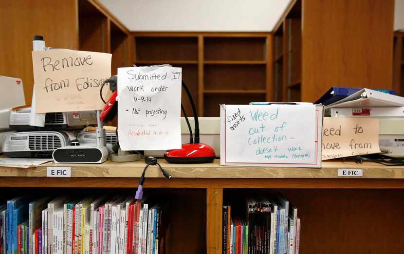 
Broken equipment sits atop library shelves, which aren’t filled with books at Edison Middle...