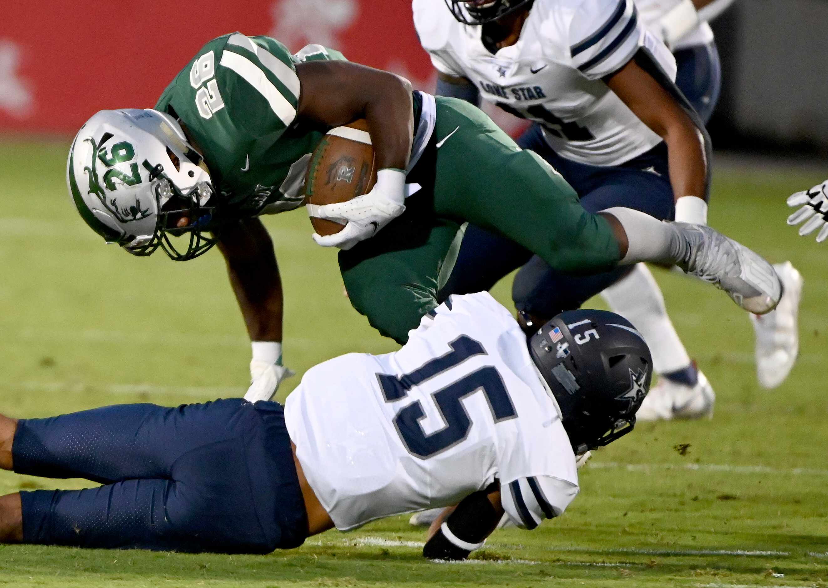 Frisco Lone Star’s JB Reynolds (15) tackles Frisco Reedy’s Aaron Daniels (26) in the first...
