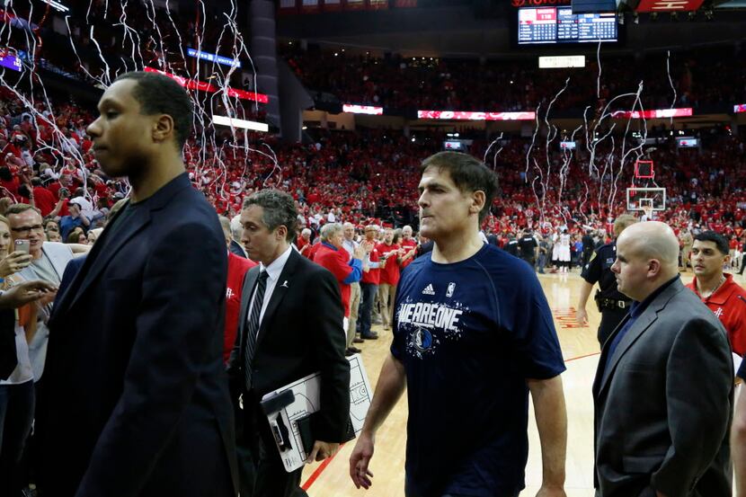 Dallas Mavericks owner Mark Cuban and team exit the court after losing to the Houston...
