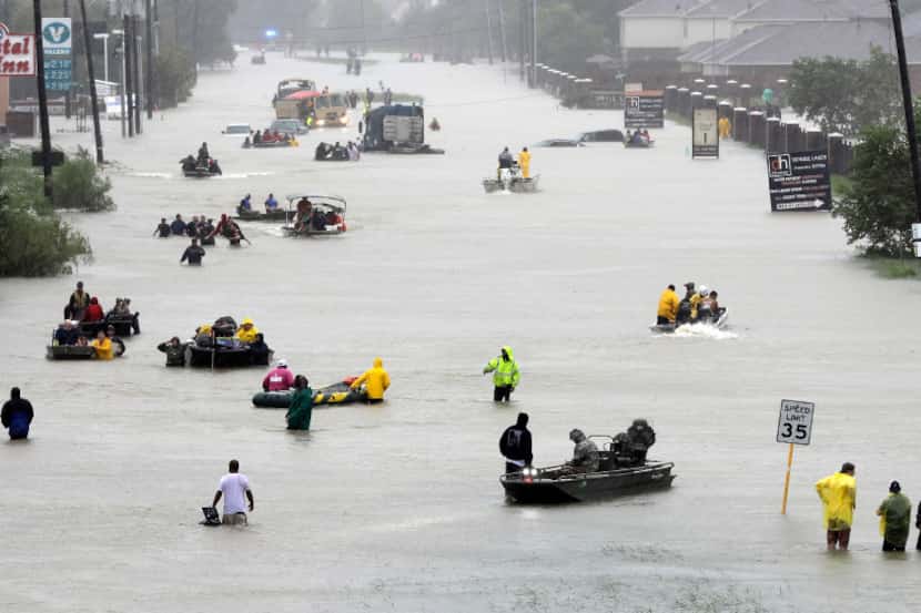 Rescue boats filled a flooded Houston street on Aug. 28. (David J. Phillip/The Associated...