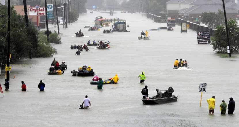 Rescue boats fill a flooded Houston street as victims are evacuated during Tropical Storm...