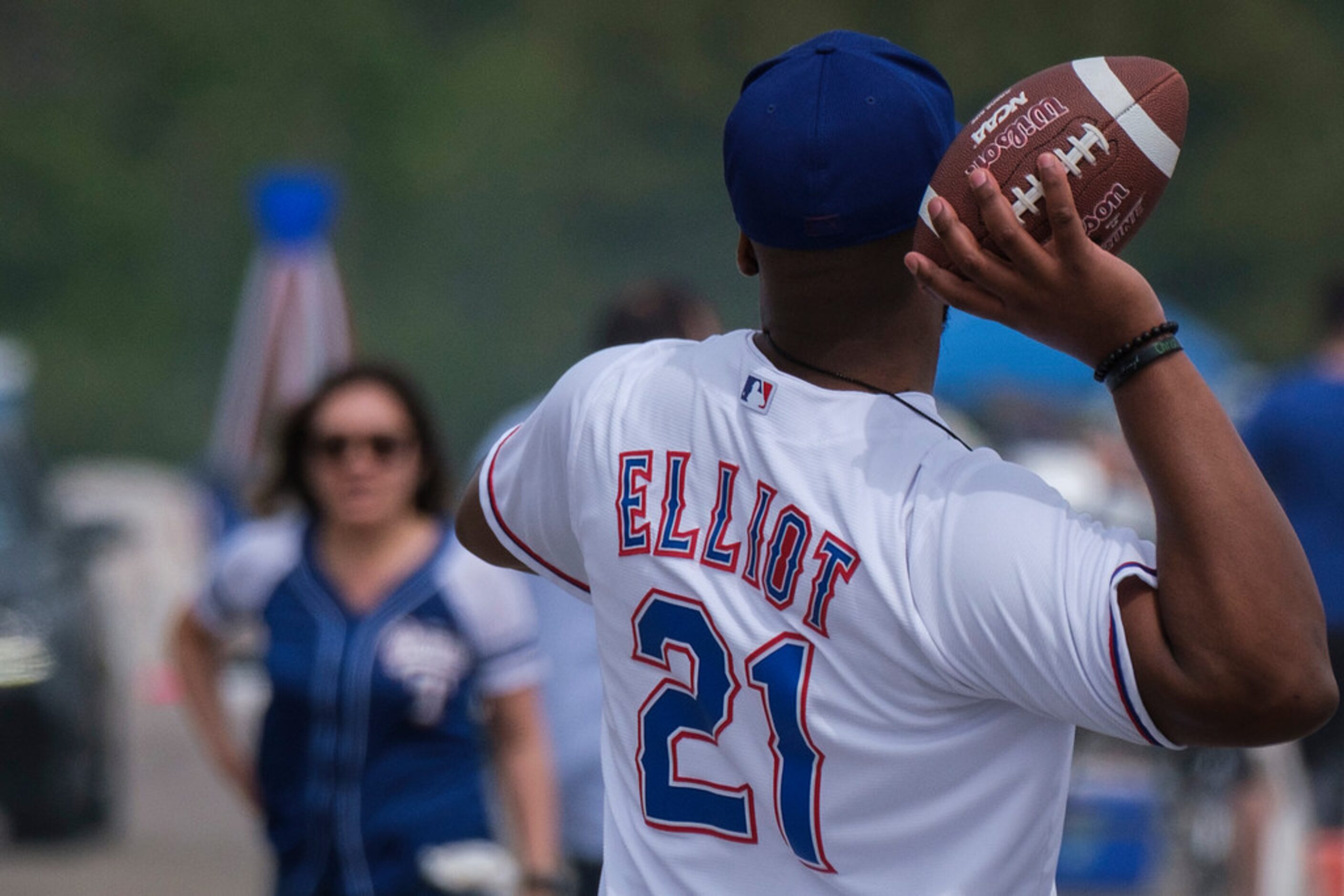 Texas Rangers fan Pierre LeBlanc wears as Rangers jersey with the number of Dallas Cowboys...