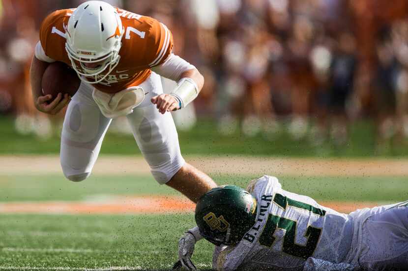 Texas quarterback Shane Buechele (7) is tackled by Baylor Bears safety Blake Lynch (21) this...