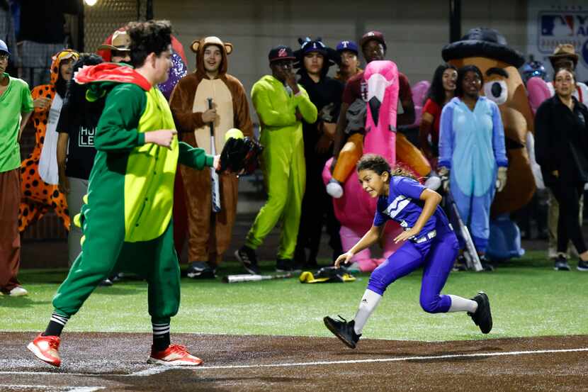 Sarah Joyce tries to reach home plate safely during the annual Halloween exhibition game...