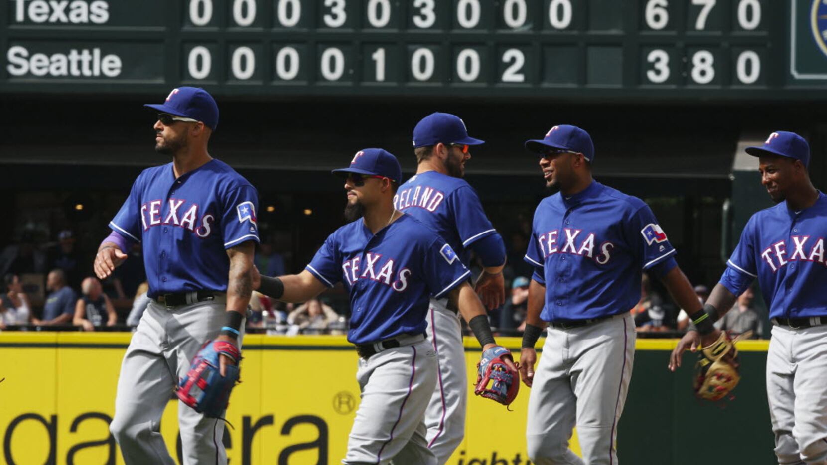 The Texas Rangers leave the field after defeating the Mariners on Sunday, June 12, 2016, at...