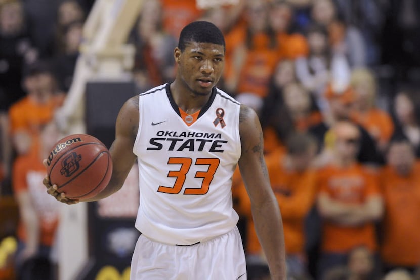 Oklahoma State guard Marcus Smart holds the ball during an NCAA basketball game in...