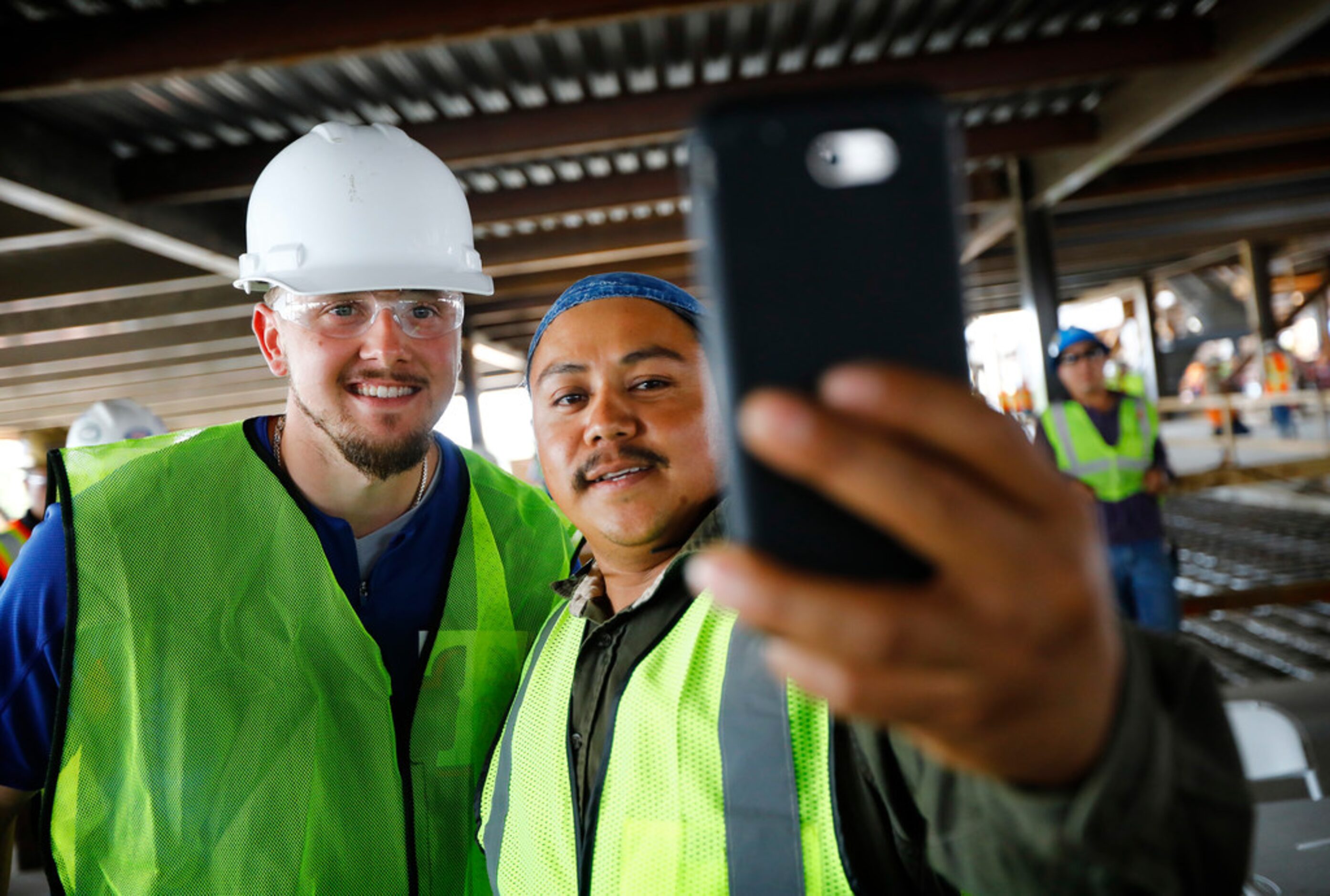 Texas Rangers baseball player Ryan Rua (left) took a selfie with construction worker Adrian...