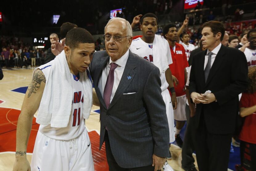 Coach Larry Brown hugs Southern Methodist guard Nic Moore (11)  after they defeated Memphis...