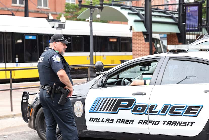 Police conferred in the parking lot near the West End DART light rail station on Thursday,...