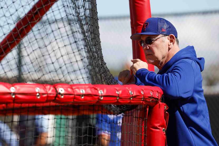 Texas Rangers manager Bruce Bochy observes batting practice during a spring training workout...