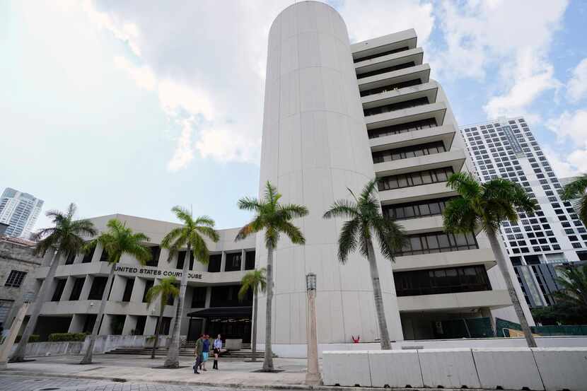 People walk outside the C. Clyde Atkins Federal Courthouse building in Miami, June 9, 2023....