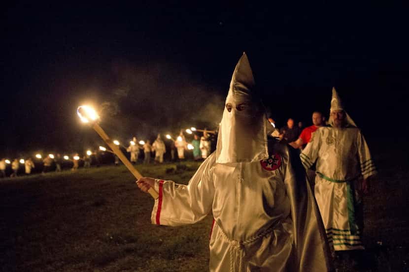 Members of the Ku Klux Klan participate in cross burnings in a April after a "white pride"...