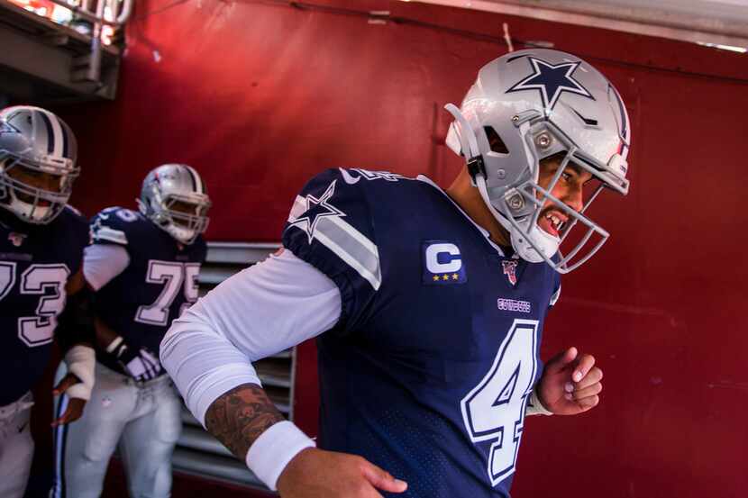 Dallas Cowboys quarterback Dak Prescott (4) runs through the tunnel before an NFL game...