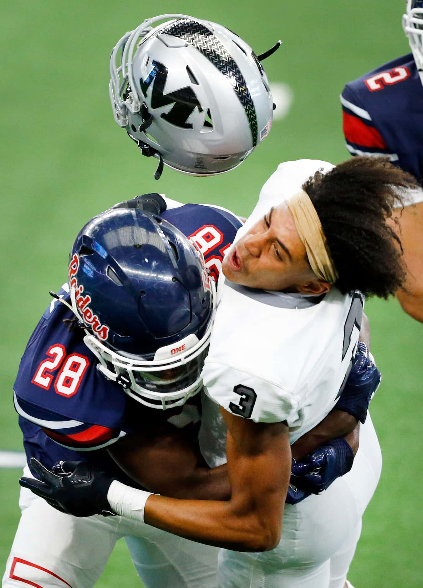 Denton Ryan defensive back Kaden Kelly (28) puts a hit on Arlington Martin receiver Cydd...