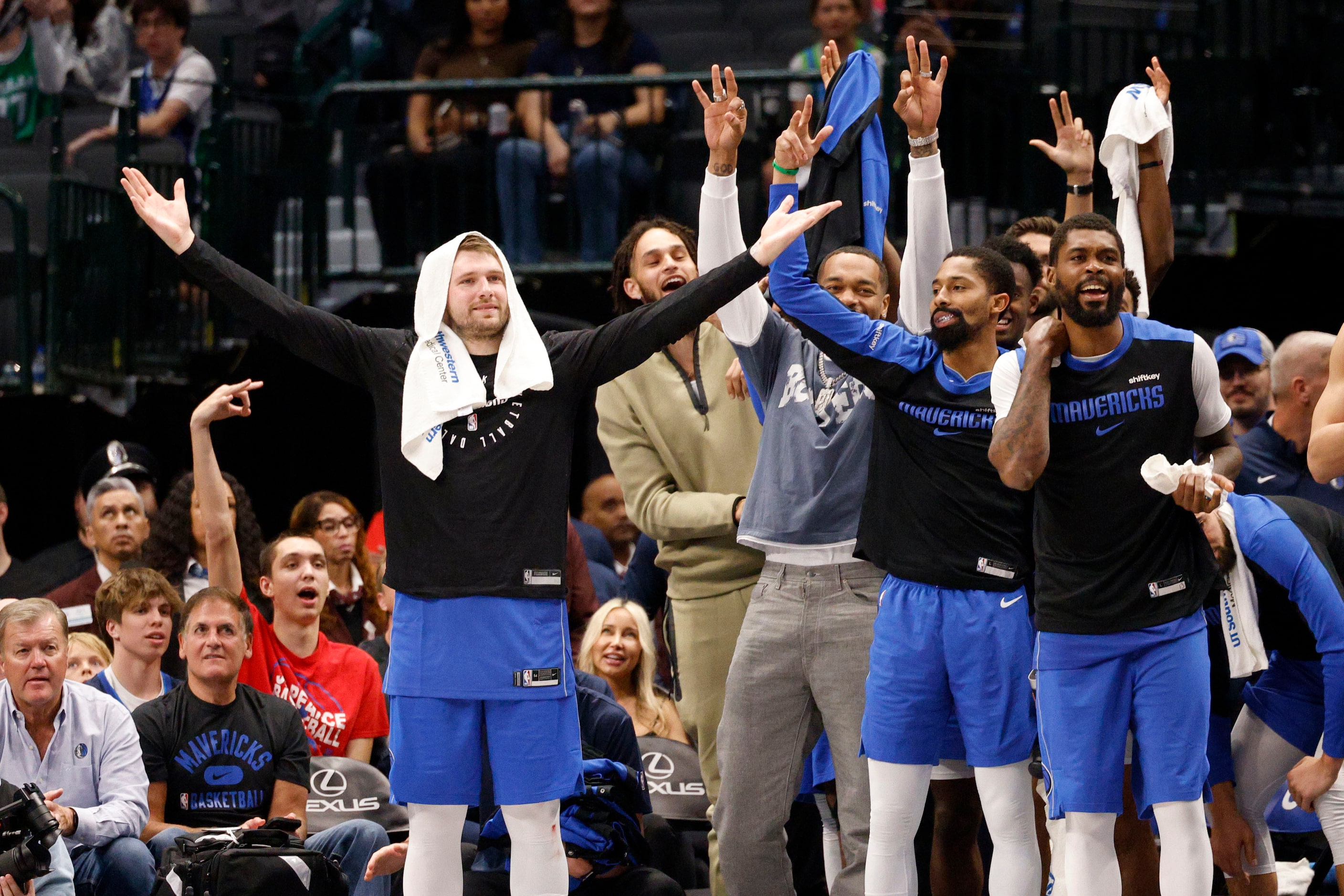 Dallas Mavericks guard Luka Doncic (77), left, and his teammates react just before the game...