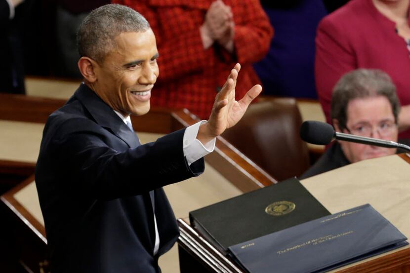  President Barack Obama waves before giving his State of the Union address before a joint...
