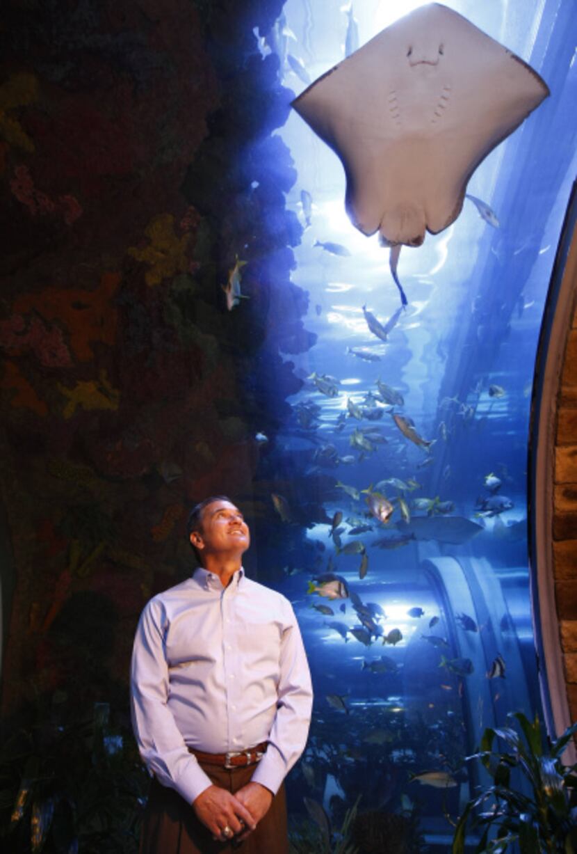 Greg Barron poses looks up at the giant aquarium that welcomes worshipers at Inspiring Body...