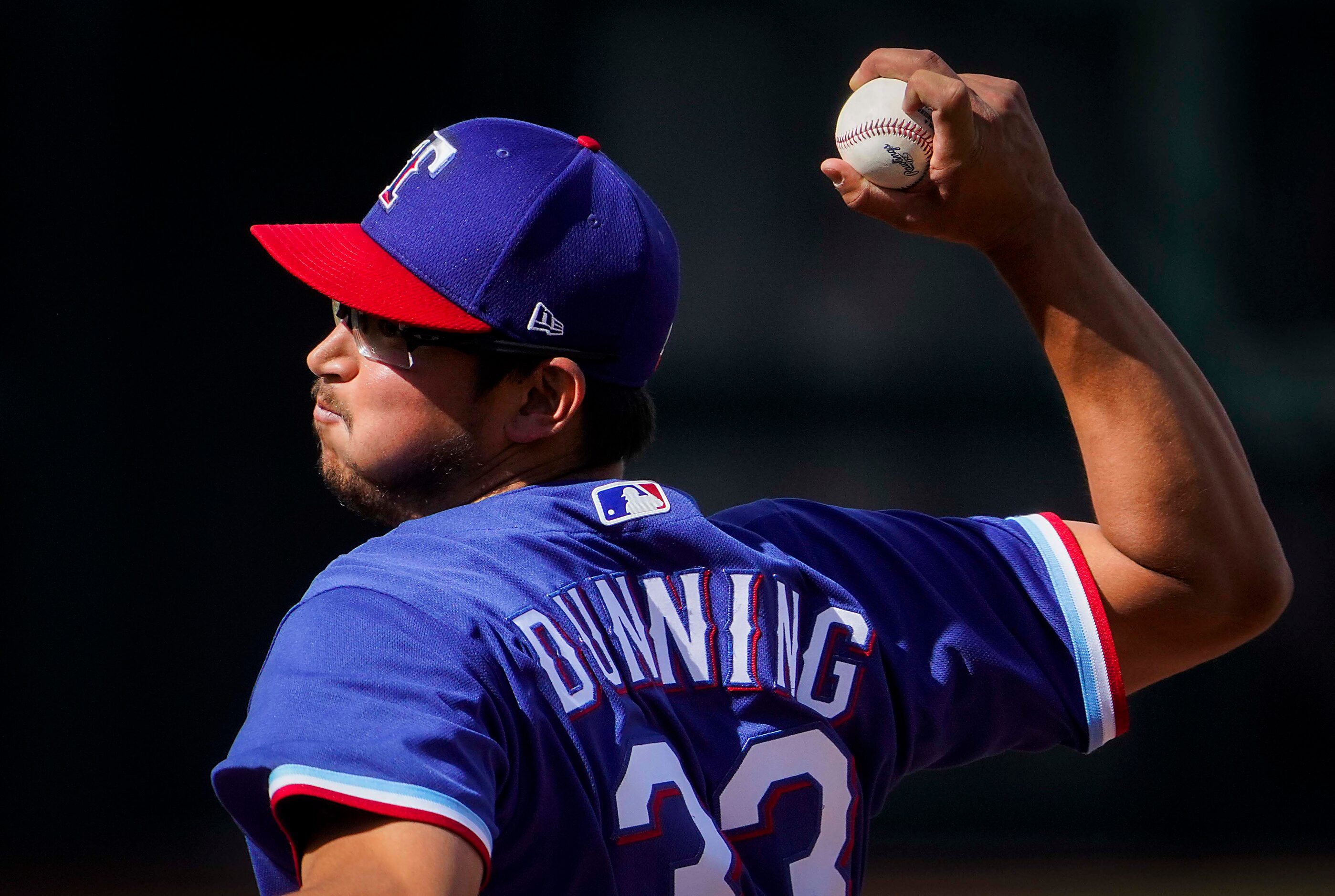 Texas Rangers pitcher Dane Dunning delivers during the seventh inning of a spring training...