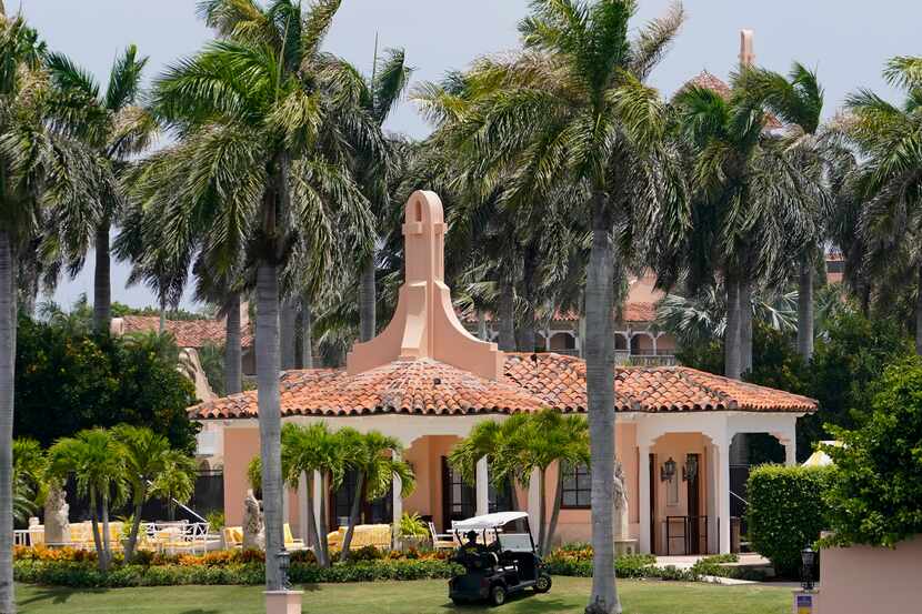 Security moves in a golf cart at former President Donald Trump's Mar-a-Lago estate, Tuesday,...