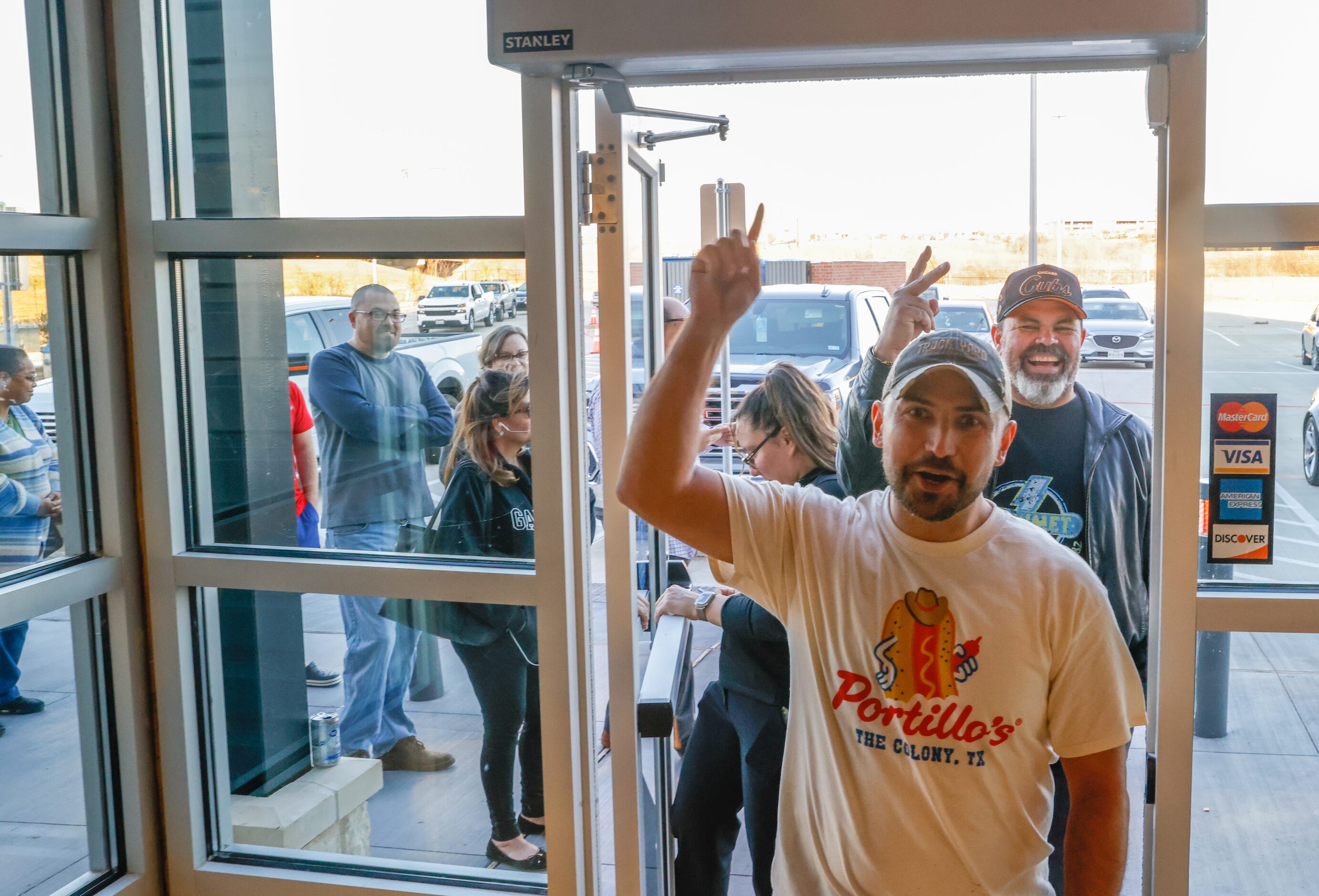 Nick Tague (center) and Ely Martinez, both Chicago natives, hold up a one and two with their...