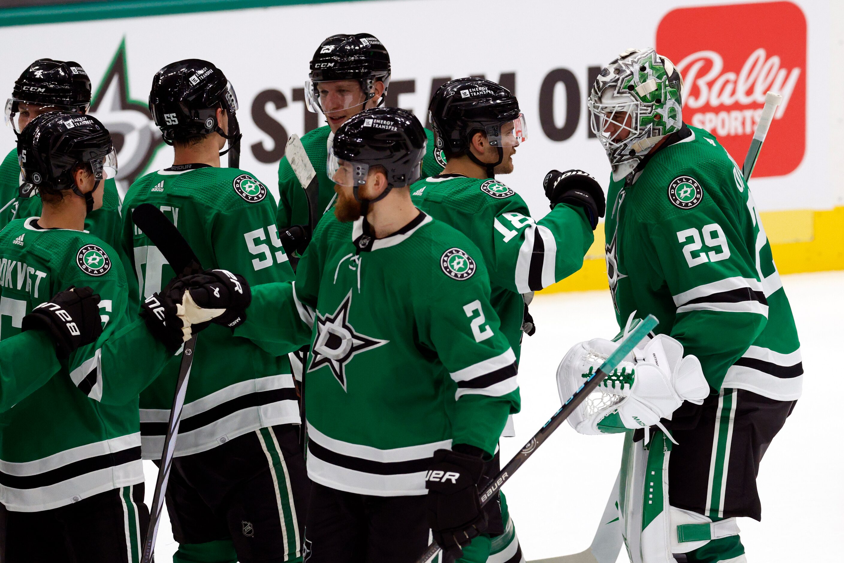 Dallas Stars center Sam Steel (18) congratulates goaltender Jake Oettinger (29) after making...