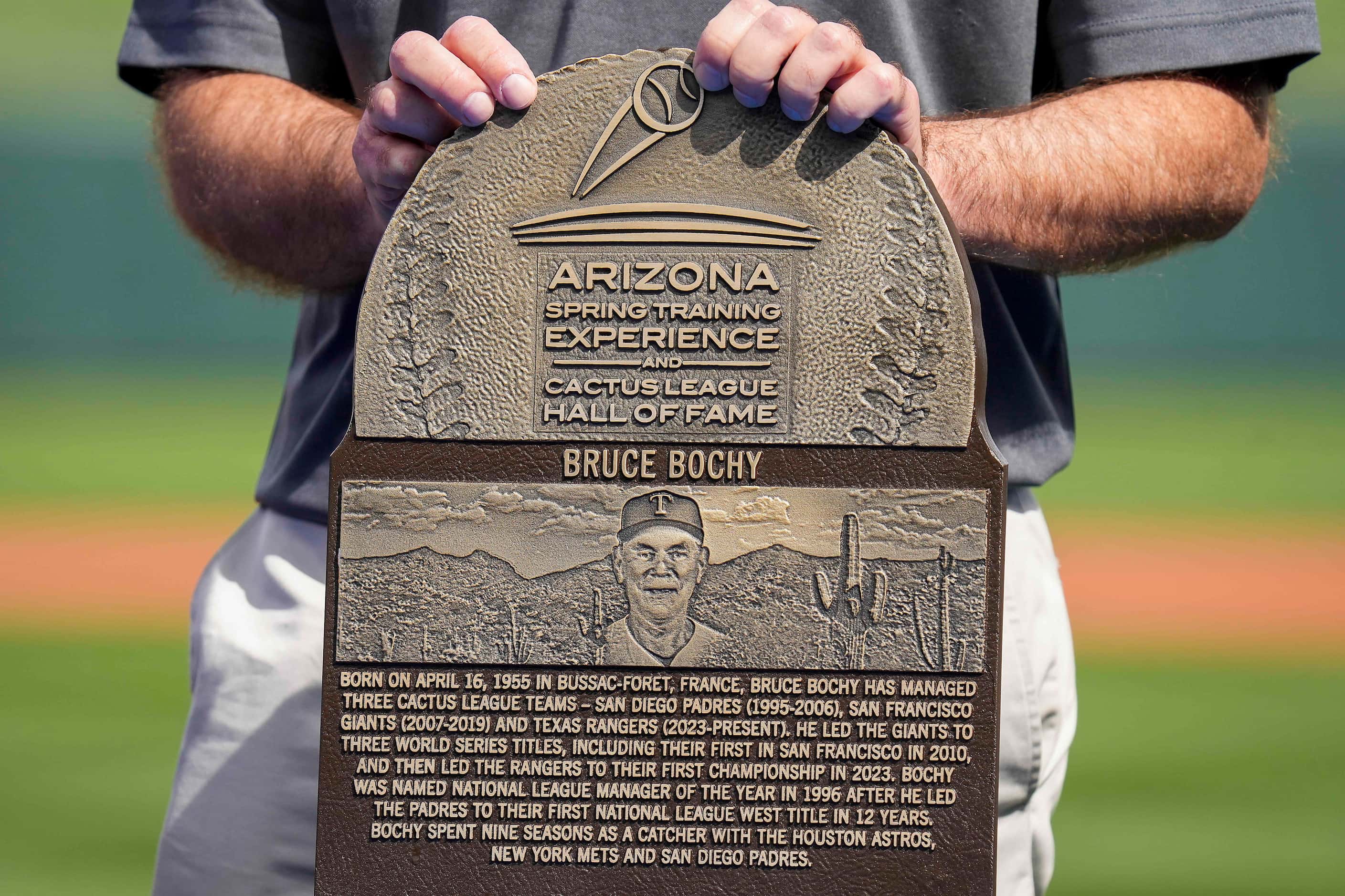 A plaque is presented to Texas Rangers manager Bruce Bochy commemorating his induction into...